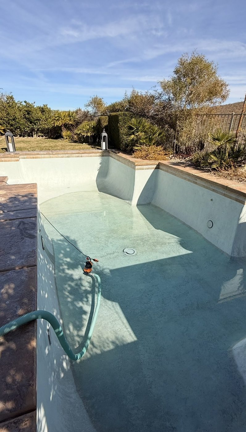 Submersible pump draining a residential pool in Las Vegas