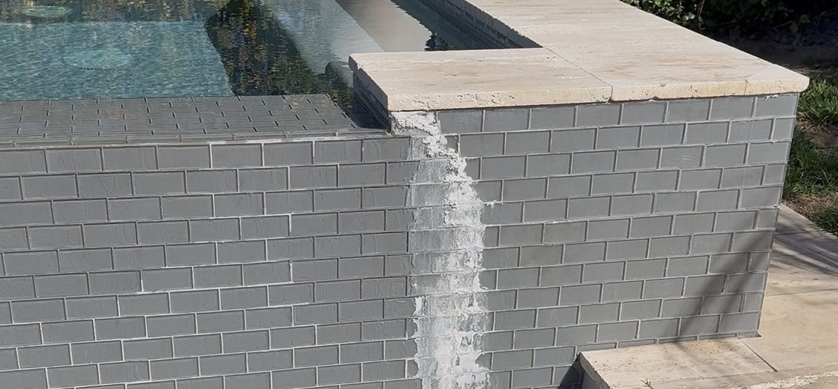 White calcium scale running down a raised spa wall in Las Vegas